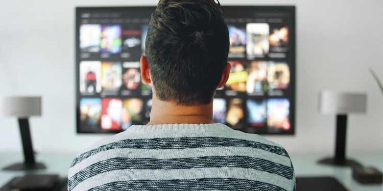 Student watching movies about university lifestyle